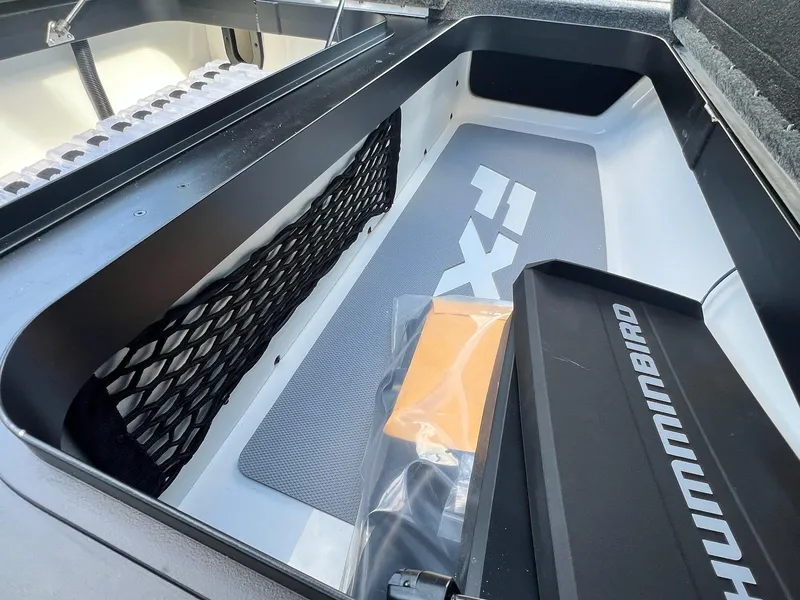 Slide: The Image of 2025 Skeeter FXR21 LE boat storage compartment with Humminbird accessory. - 21