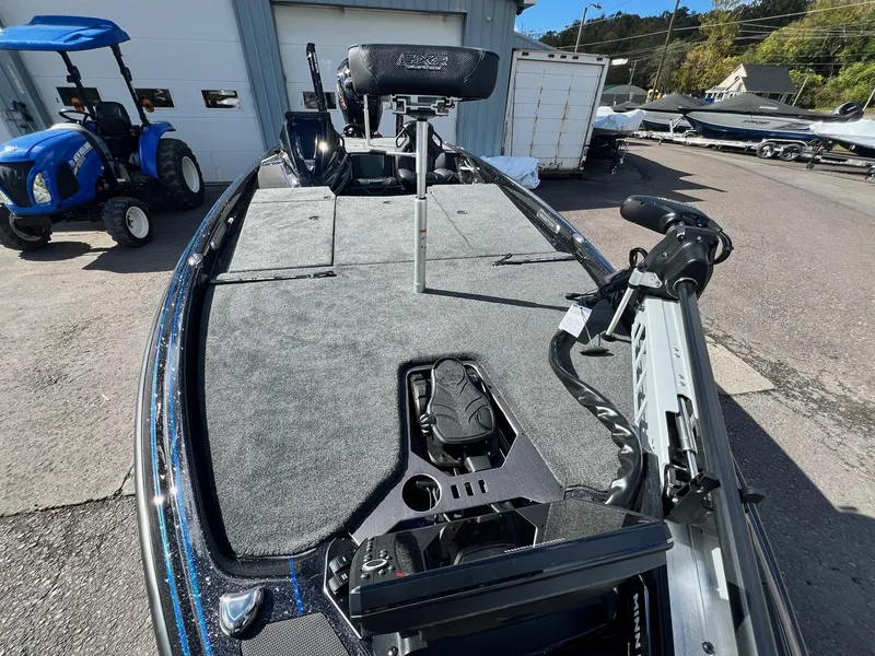Slide: The Image of 2025 Skeeter FXR21 LE boat deck with fishing equipment and controls. - 28