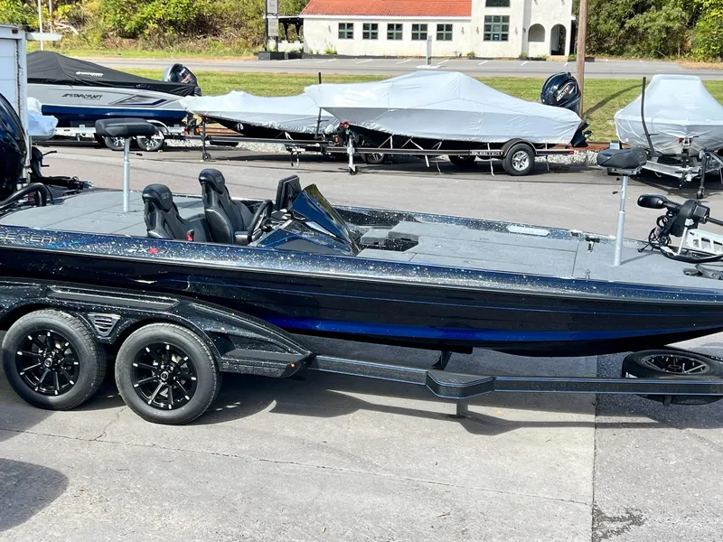 Slide: The Image of 2025 Skeeter FXR21 LE bass boat on trailer, parked outdoors. - 29