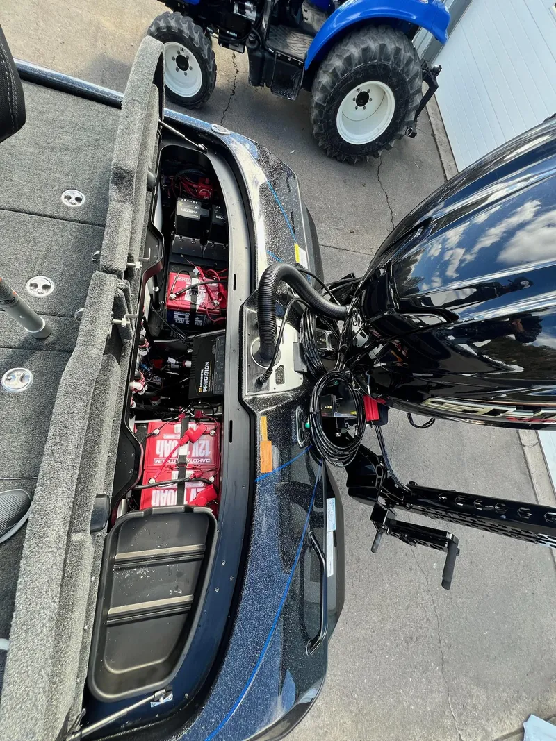 Slide: The Image of 2025 Skeeter FXR21 LE boat with open battery compartment and visible engine. - 30