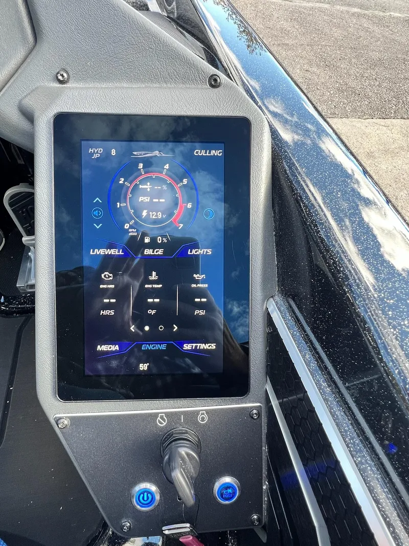 Slide: The Image of 2025 Skeeter FXR21 LE boat dashboard with digital display and control panel. - 4