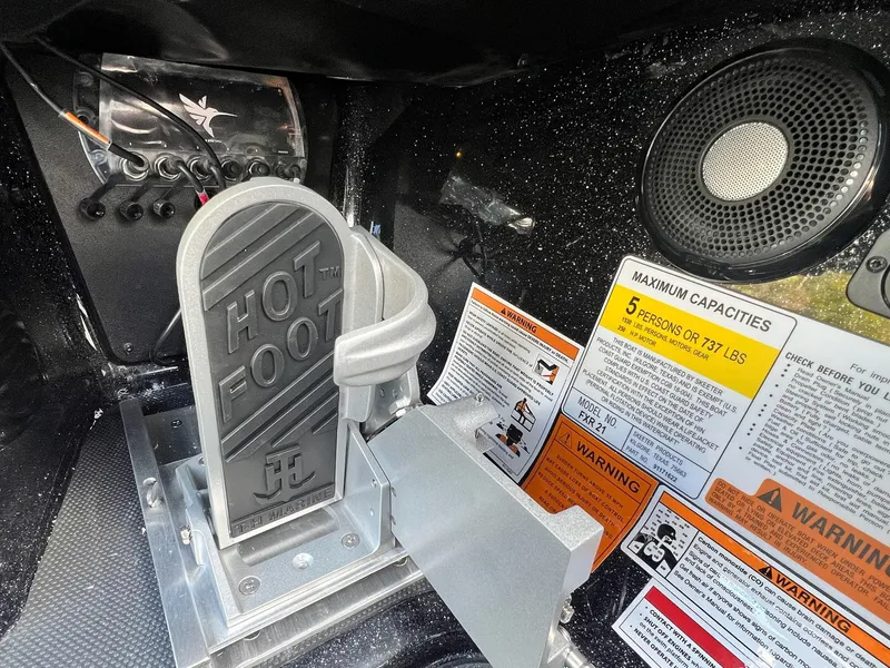 Slide: The Image of 2025 Skeeter FXR21 LE boat controls with Hot Foot pedal and capacity warnings. - 40