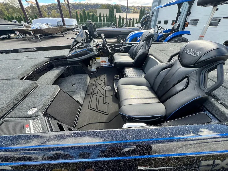 Slide: The Image of 2025 Skeeter FXR21 LE boat interior with sleek black seats and modern dashboard. - 45