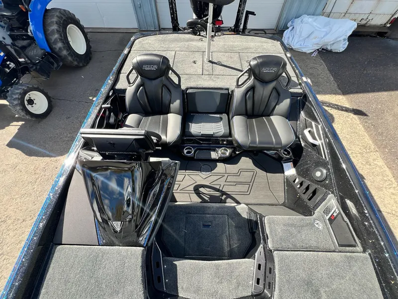 Slide: The Image of 2025 Skeeter FXR21 LE boat interior with dual seats and advanced dashboard. - 46