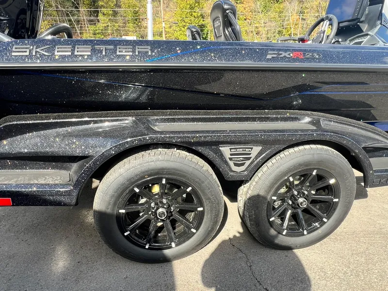 Slide: The Image of 2025 Skeeter FXR21 LE boat trailer with black alloy wheels. - 49