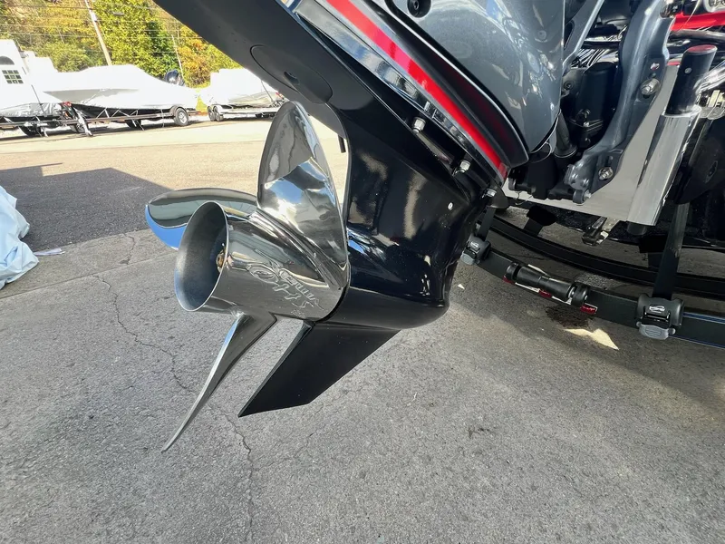 Slide: The Image of 2025 Skeeter FXR21 LE boat propeller, shiny chrome finish, parked on concrete. - 6