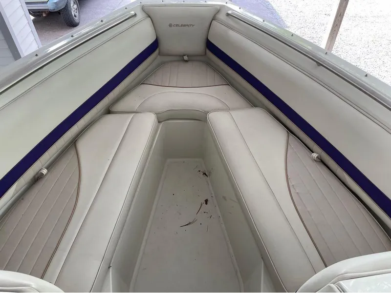 Slide: The Image of 1996 Celebrity 220 boat interior with white and blue seating. - 11