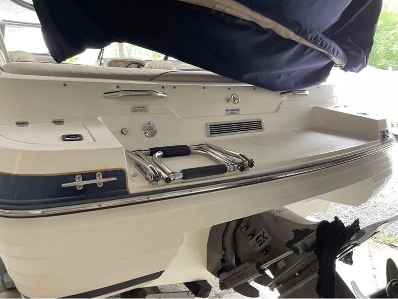Slide: The Image of 1996 Celebrity 220 boat stern with ladder and covered seating area. - 12