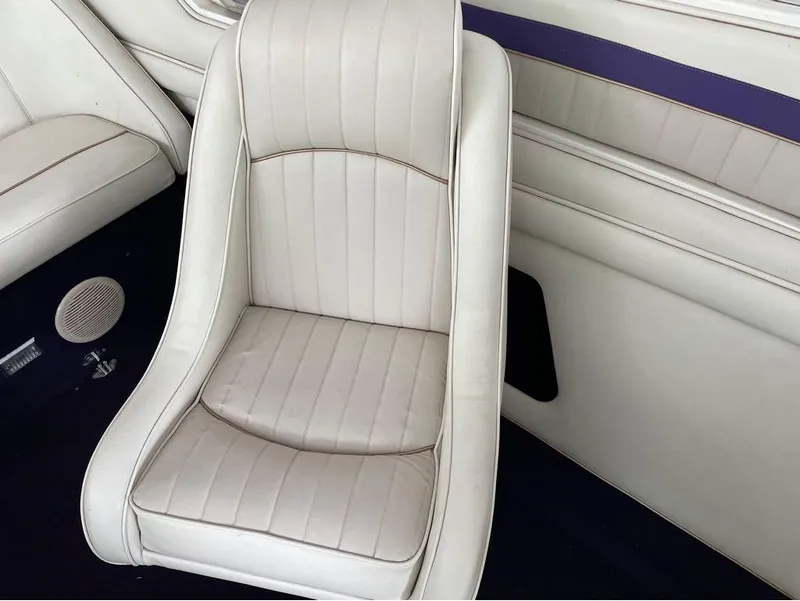 Slide: The Image of White leather seat in a 1996 Celebrity 220 boat interior. - 14