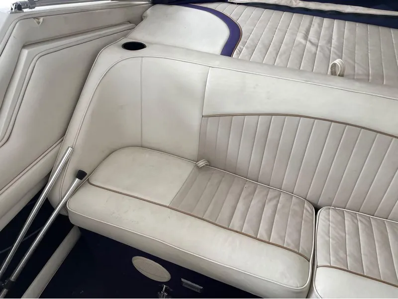 Slide: The Image of White leather seating in a 1996 Celebrity 220 boat interior. - 18