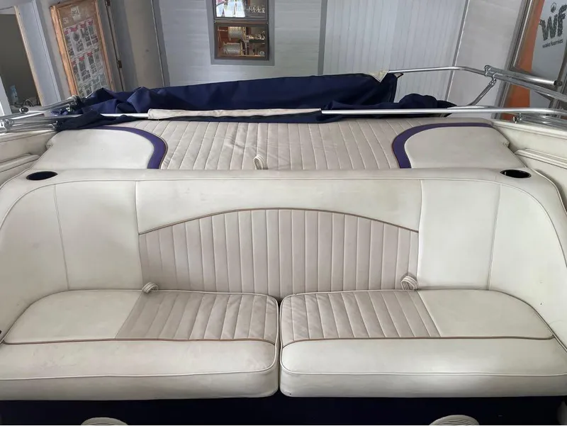 Slide: The Image of White leather seating on a 1996 Celebrity 220 boat interior. - 20