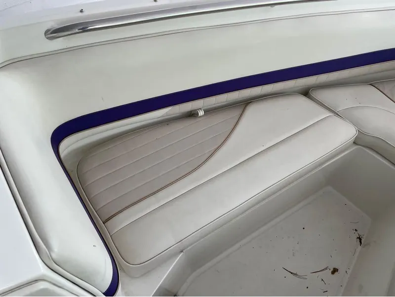 Slide: The Image of White and blue interior seating of a 1996 Celebrity 220 boat. - 4