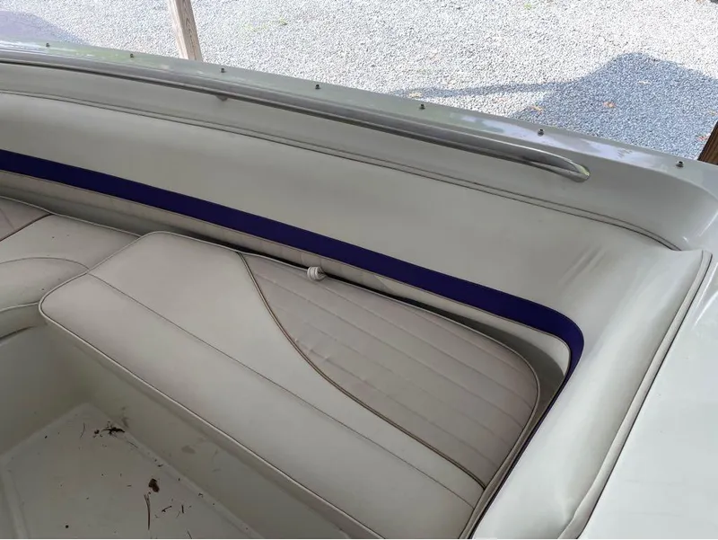 Slide: The Image of Interior of a 1996 Celebrity 220 boat with white and blue seating. - 9