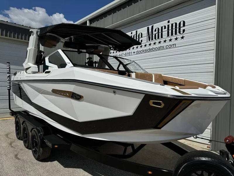 Slide: The Image of 2025 Nautique PARAGON 23 boat on trailer at Dockside Marine dealership. - 1