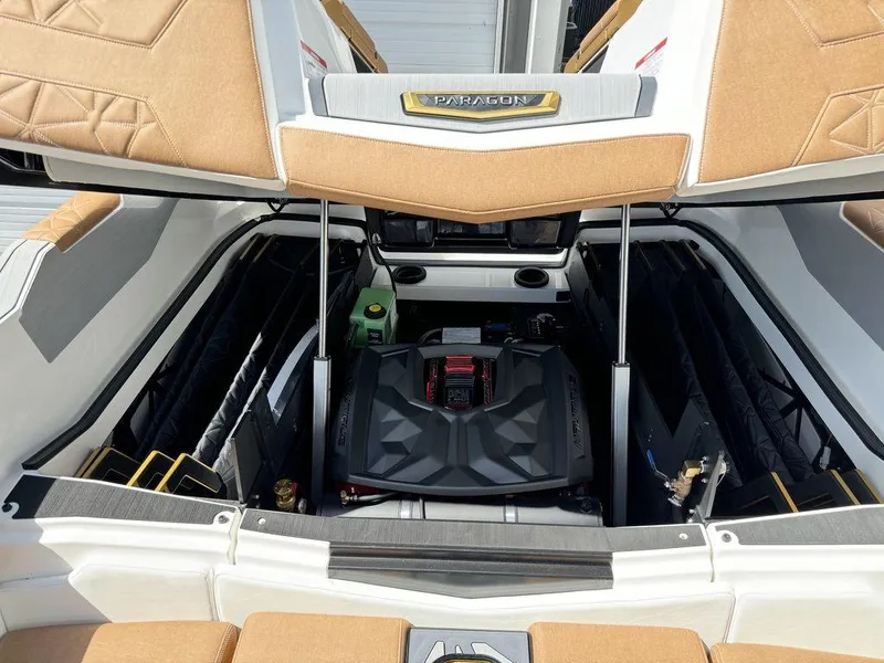 Slide: The Image of 2025 Nautique PARAGON 23 engine compartment with open hatch, showcasing interior details. - 14
