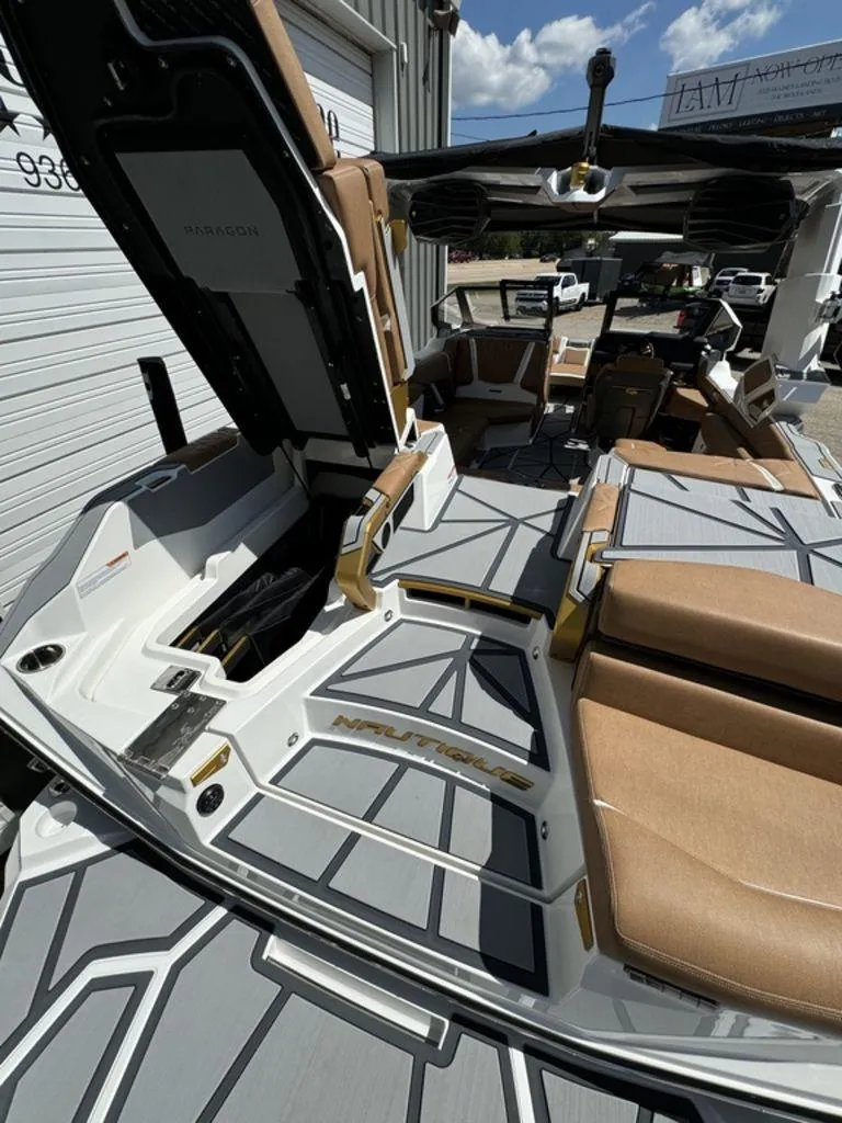 Slide: The Image of 2025 Nautique PARAGON 23 boat interior with tan seating and modern design. - 9