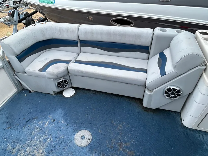 Slide: The Image of 2003 Starcraft 200 Fish Pontoon boat seating with blue and gray upholstery. - 10