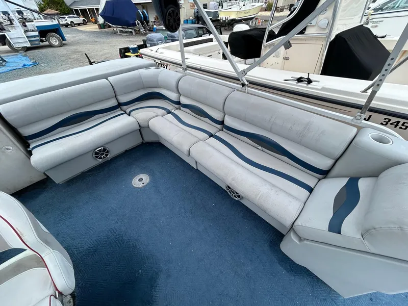Slide: The Image of 2003 Starcraft 200 Fish Pontoon boat interior with blue and white seating. - 13