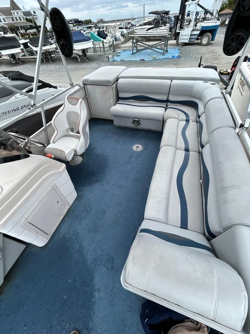Slide: The Image of 2003 Starcraft 200 Fish Pontoon with spacious seating and blue carpeted deck. - 3