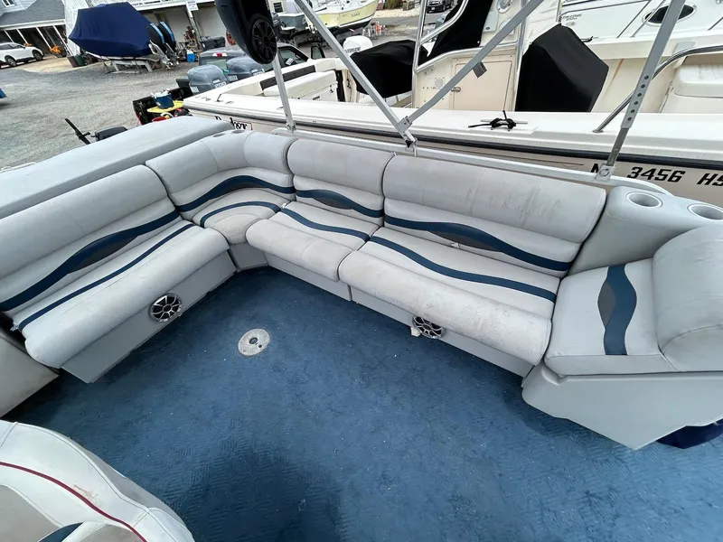 Slide: The Image of 2003 Starcraft 200 Fish Pontoon boat interior with blue and white seating and carpet. - 5