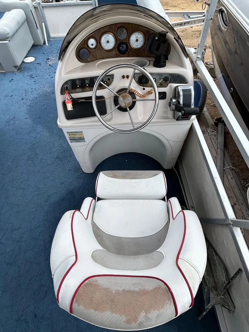 Slide: The Image of 2003 Starcraft 200 Fish Pontoon boat dashboard with steering wheel and gauges. - 6