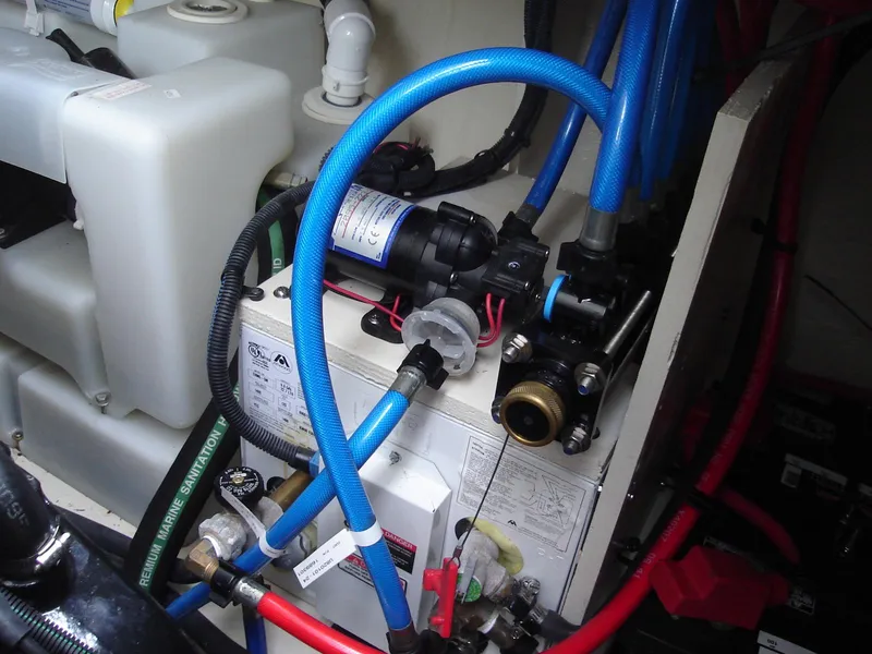 Slide: The Image of Engine compartment of 2005 Sea Ray 340 Sundancer with blue and red hoses. - 22