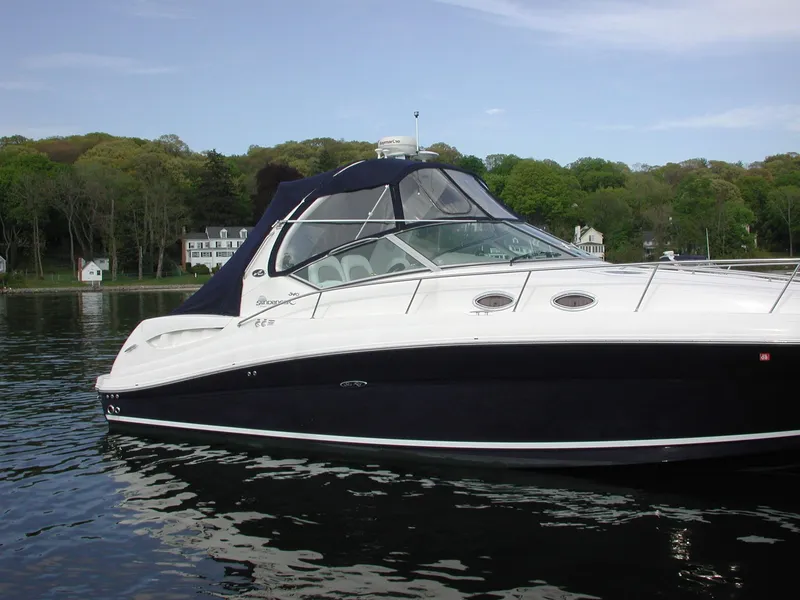 Slide: The Image of 2005 Sea Ray 340 Sundancer boat on calm water with scenic background. - 3