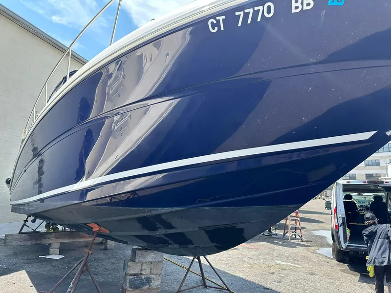 Slide: The Image of 2005 Sea Ray 340 Sundancer boat on stands, blue hull, registration CT 7770 BB. - 4