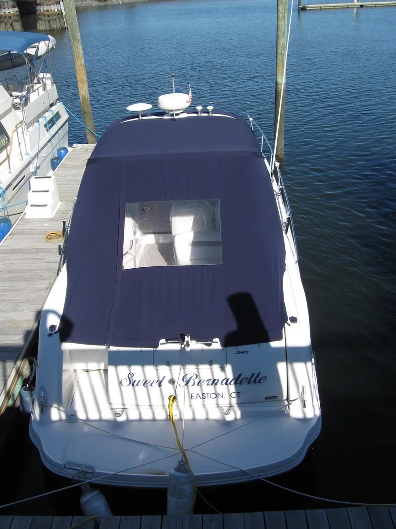 Slide: The Image of 2005 Sea Ray 340 Sundancer docked, covered with navy canvas, rear view. - 7