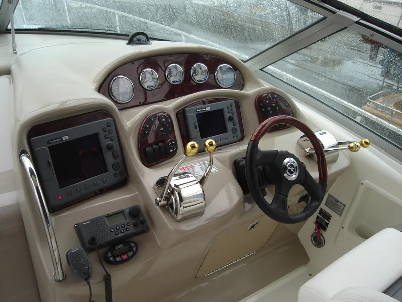 Slide: The Image of 2005 Sea Ray 340 Sundancer helm with gauges, controls, and navigation equipment. - 8