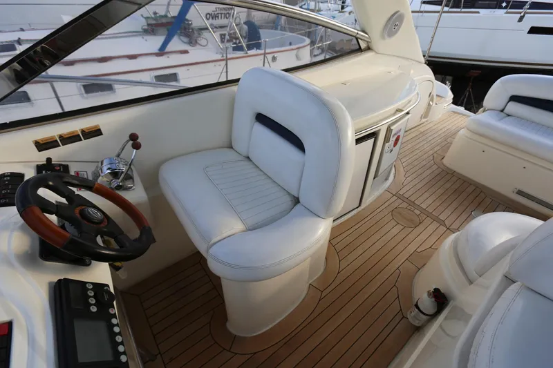 Slide: The Image of Interior of 1998 Sunseeker Camargue 44 yacht with white seating and wooden flooring. - 12