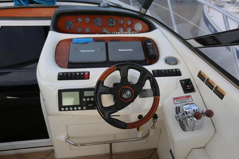 Slide: The Image of Sunseeker Camargue 44 yacht helm, featuring steering wheel and control panel, 1998 model. - 13