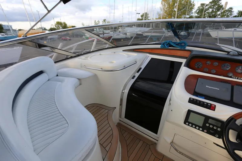 Slide: The Image of Interior view of 1998 Sunseeker Camargue 44 yacht cockpit with white seating and control panel. - 14