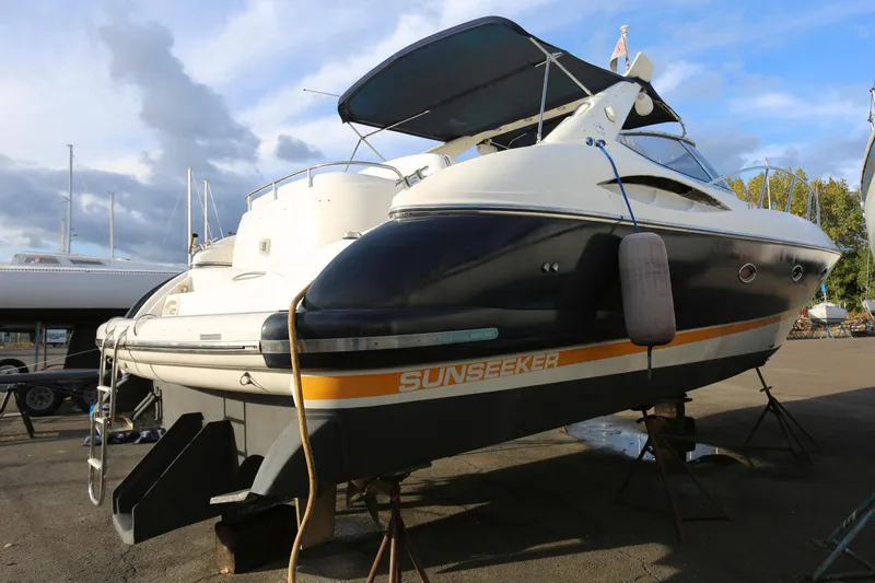 Slide: The Image of 1998 Sunseeker Camargue 44 yacht on dry dock, showcasing sleek design and elegant lines. - 2