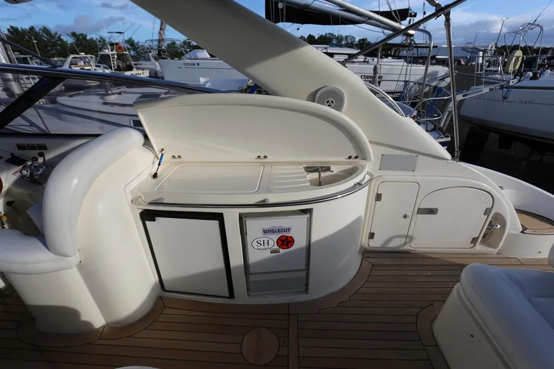 Slide: The Image of Sunseeker Camargue 44 yacht deck with kitchenette, 1998 model, featuring sleek design and wood flooring. - 20