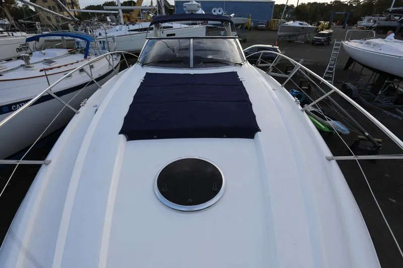 Slide: The Image of Sunseeker Camargue 44 yacht, 1998 model, docked with sleek white deck and blue cover. - 23