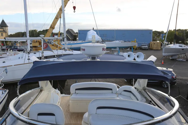 Slide: The Image of Sunseeker Camargue 44 yacht, 1998 model, docked with blue canopy and white seating. - 24