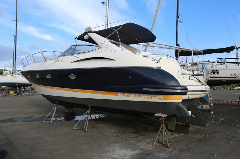 Slide: The Image of 1998 Sunseeker Camargue 44 yacht on dry dock, blue and white exterior. - 3