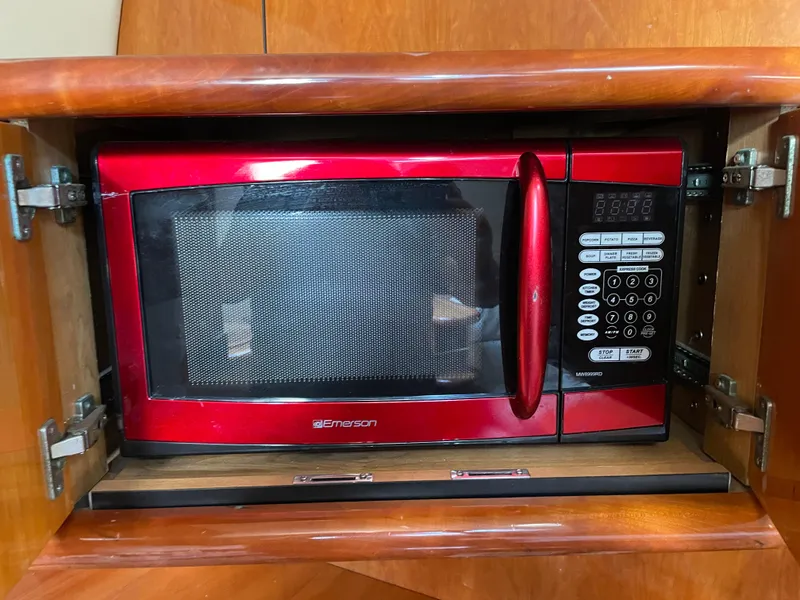 Slide: The Image of Red Emerson microwave in wooden cabinet on Sunseeker Camargue 44 yacht, 1998 model. - 32