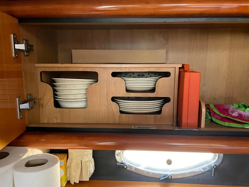 Slide: The Image of Cabinet storage with dishes in a 1998 Sunseeker Camargue 44 yacht. - 33