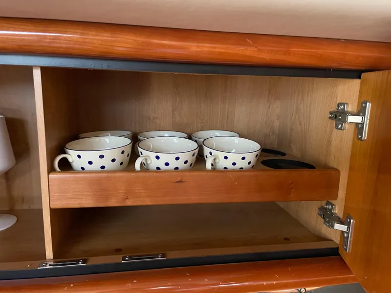 Slide: The Image of Polka dot cups in wooden cabinet on 1998 Sunseeker Camargue 44 yacht. - 35
