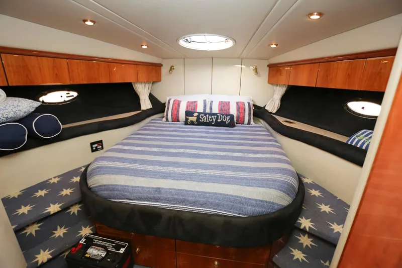 Slide: The Image of Luxurious 1998 Sunseeker Camargue 44 yacht bedroom with striped bedding and wooden cabinets. - 38