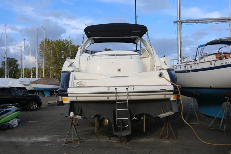 Slide: The Image of 1998 Sunseeker Camargue 44 yacht on dry dock, rear view with ladder and canopy. - 4