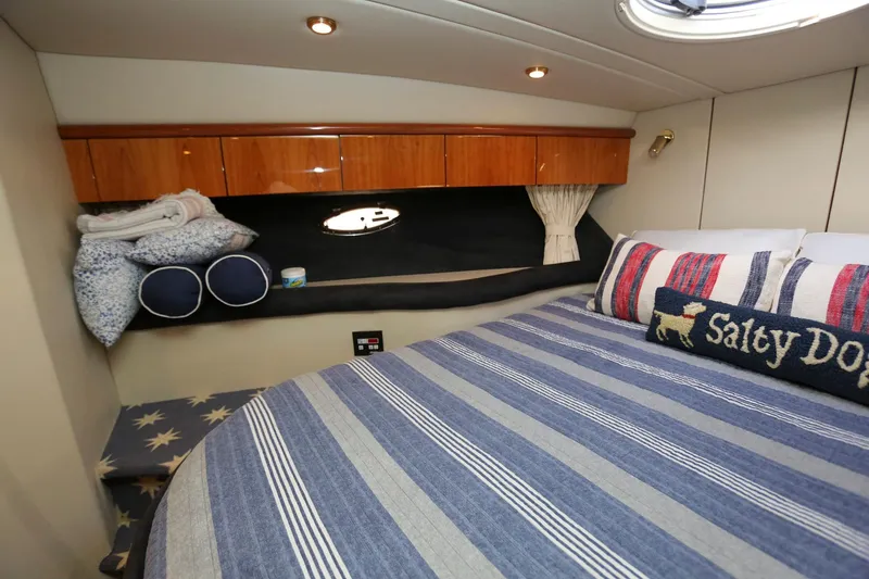 Slide: The Image of Cozy cabin interior of 1998 Sunseeker Camargue 44 yacht with striped bedding. - 40