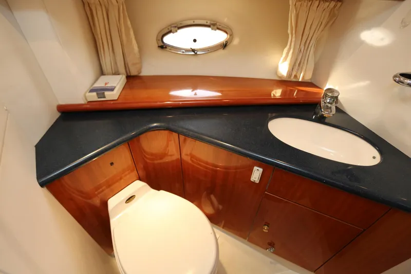 Slide: The Image of Luxurious bathroom in 1998 Sunseeker Camargue 44 yacht with wood cabinetry and modern fixtures. - 42