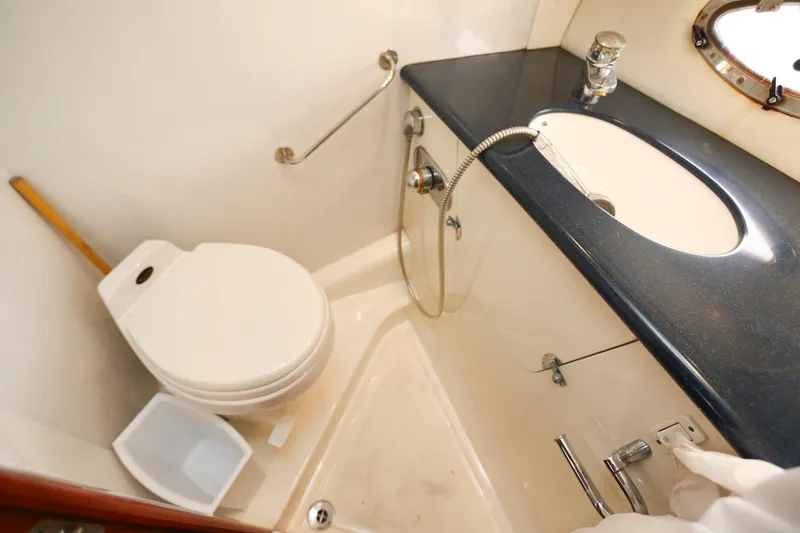 Slide: The Image of Bathroom interior of 1998 Sunseeker Camargue 44 yacht, featuring toilet and sink. - 44