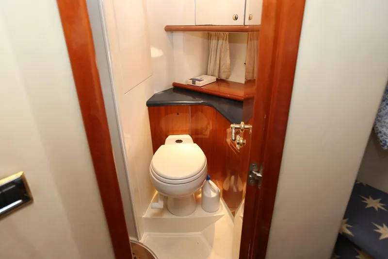 Slide: The Image of Compact bathroom in 1998 Sunseeker Camargue 44 yacht with wooden accents and storage. - 45