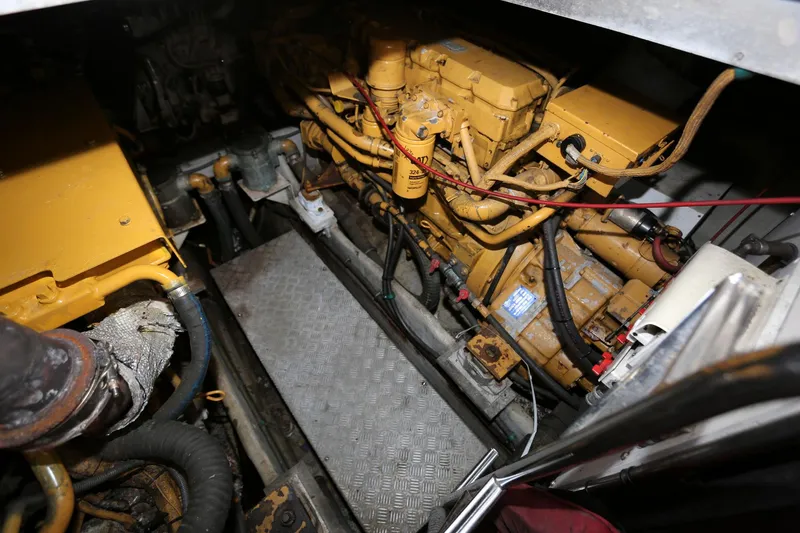 Slide: The Image of Engine room of 1998 Sunseeker Camargue 44 yacht, featuring yellow machinery and metal flooring. - 46