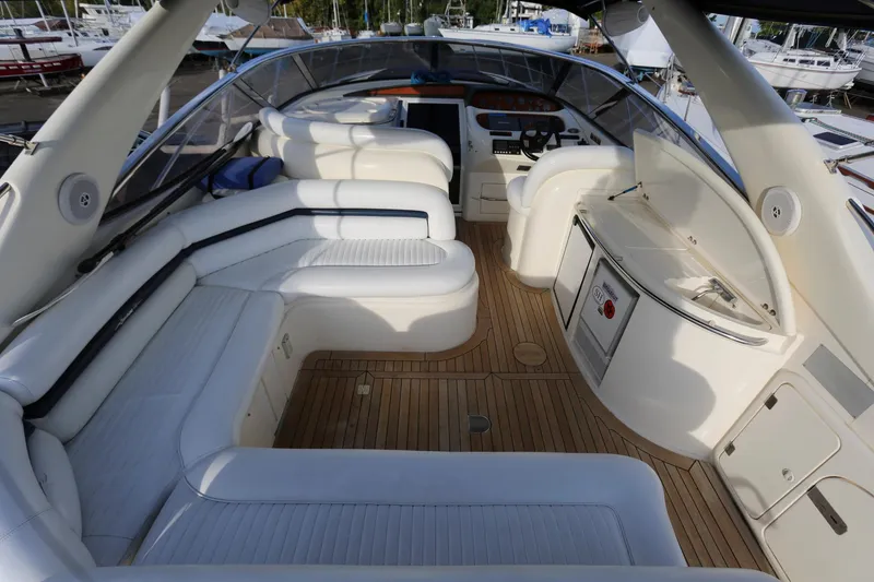 Slide: The Image of Luxurious 1998 Sunseeker Camargue 44 yacht interior with white seating and wooden flooring. - 8