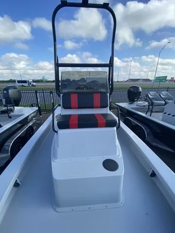 Slide: The Image of 2024 Majek M2 ILLUSION boat with red and black seating, docked under a cloudy sky. - 11